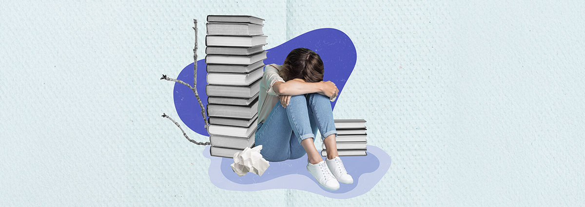 Students studying with past exam papers and study materials